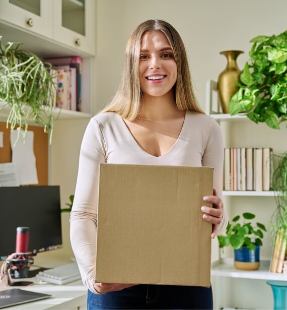 young-woman-at-home-unpacks-cardboard-box-with-onl-2024-12-08-05-26-44-utc (1)